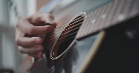 Close up of hands strumming and playing the acoustic guitar Stock Footage 306200645