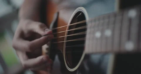 Close up of hands strumming and playing the acoustic guitar Stock Footage 306200666