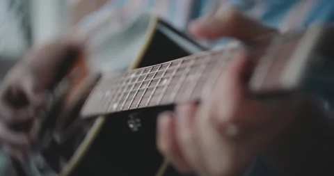 Close up of hands strumming and playing the acoustic guitar Stock Footage 306200670