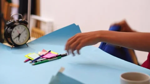 Close-up of hands Student clearing blue backpack to make room for note-taking Stock Footage 335124103