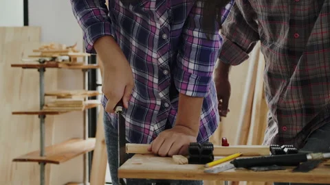 Close up hands student practicing woodworking from elderly carpenter Stock Footage 159664211