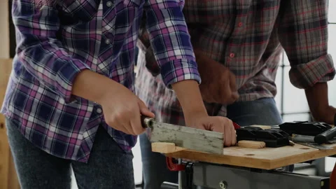 Close up hands student practicing woodworking from elderly carpenter Stock Footage 159664647
