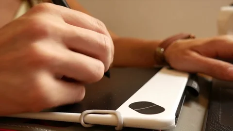 Close: hands with stylus on drawing tablet Stock Footage 94480127