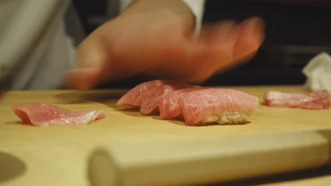 Close-up on the hands of a sushi chef preparing sushi Stock-Footage 96241498