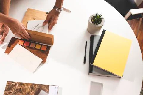 Close up of hands on the table during an office presentation with three young Stock Photos