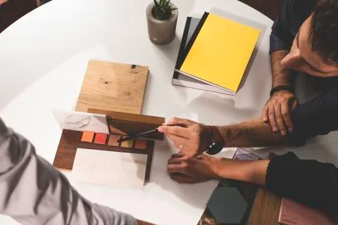 Close up of hands on the table during an office presentation with three young Stock Photos