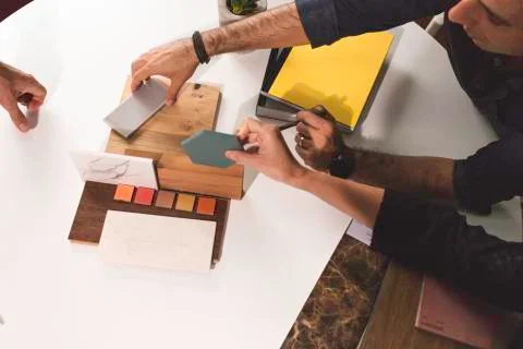 Close up of hands on the table during an office presentation with three young Stock Photos