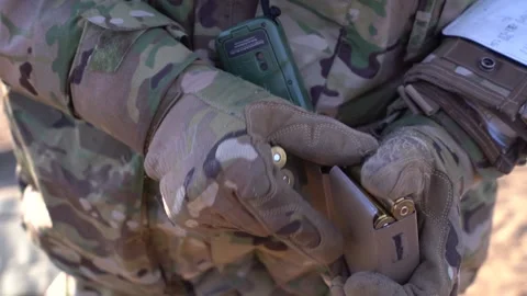 Close-up of hands in tactical gloves equipping the magazine with cartridges Stock Footage 220601156