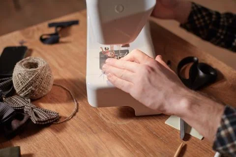Close-up hands of Tailor. Craftsman Makes rectangular blanks for Bow ties of Stock Photos