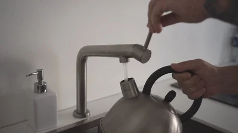 Close up hands take a water to kettle or teapot Stock Footage 110905607