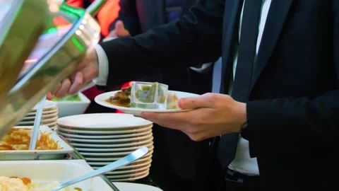 Close-up of hands taking food from a self service buffet line in a restaurant. 動画素材 328307586