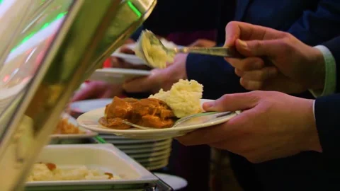Close-up of hands taking food from a self service buffet line in a restaurant. Stock Footage 328307594