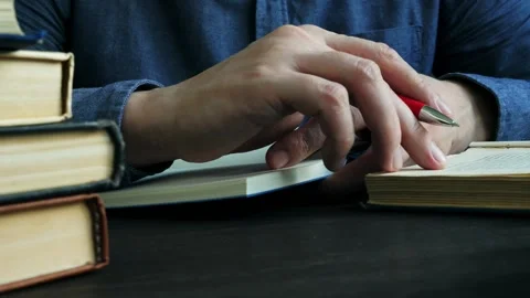 Close-up of hands taking notes in a notebook. A man is studying and reading Stock Footage 130903161