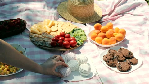 Close-up of hands taking sweet marshmallows at a picnic in the park. Stock Footage 204101153