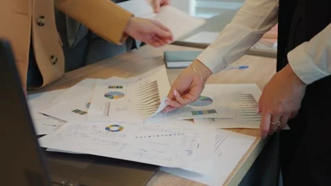 Close up hands of team analysing data for next term inveting strategy. Stock Footage 296577417