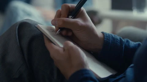 Close Up of Hands of Therapist Writing Notes in Notepad during Consultation Stock Footage 346985383