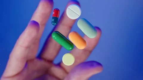 Close-up hands throwing different pills and capsules on the desk table Stock Footage 261185822