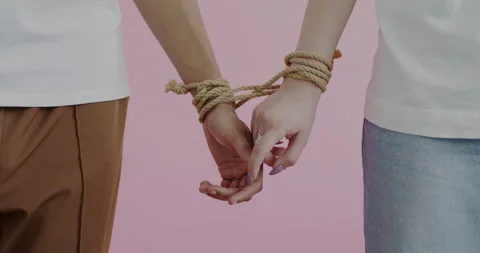 Close-up of hands tied with rope touching expressing love in committed Stock Footage 237695672