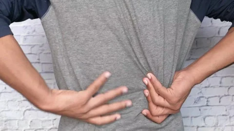 Close up hands touching back pain Massaging and Stretching Back to Ease Injury Video stock 336585230
