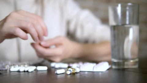 Close up of hands touching pills. The concept of health care, vitamin deficiency Stock Footage 116677783