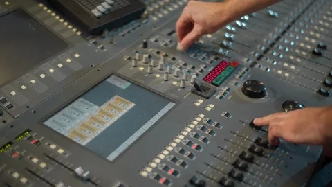 Close-up of hands tune in a mixing console. A sound director works in a studio Video stock 116018786