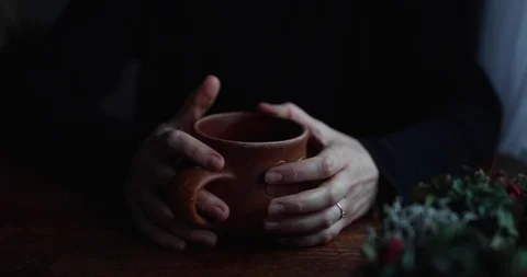 Close-up hands twist on the table ceramic brown mug Stock Footage 129710196