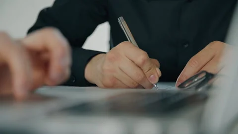 Close up hands of two businessmen working together, writing and discussing Video stock 90361884