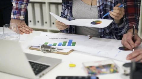 Close up of hands of two men and woman working with graphs 스톡 동영상 74244127