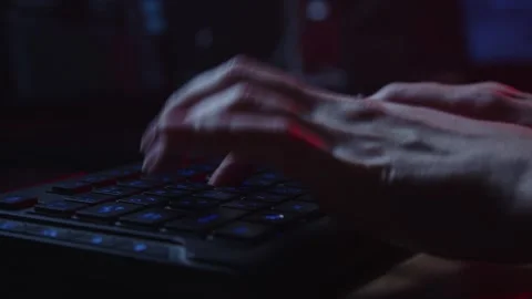 Close-Up of Hands Typing on a Backlit Keyboard in Dark Environment Stock Footage 281759694