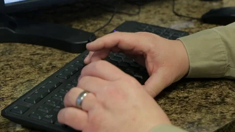Close up of hands typing on black computer keyboard in office B Video stock 125638852