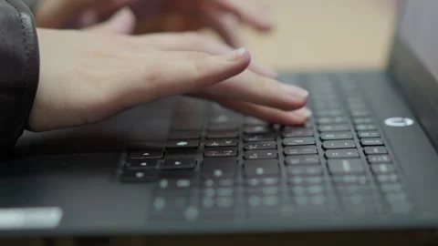 Close up of hands typing on a black laptop keyboard in a professional offic.. Stock Footage 347410351