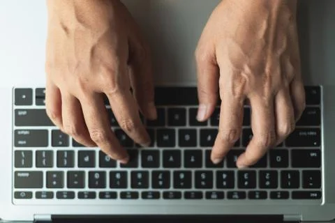 Close up hands typing a button on the laptop Stock Photos