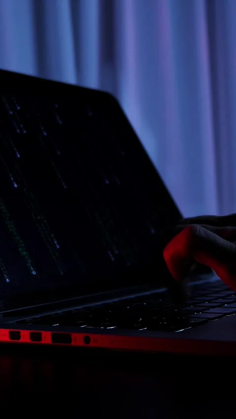 Close up of hands typing code on laptop keyboard in dark office. Vertical video Stock Footage 318162520
