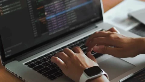 Close up of hands typing code on a laptop keyboard technology, Programmer man Video stock 334585754