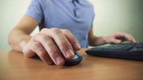 Close up of hands typing on computer keyboard and mouse Video stock 84267341