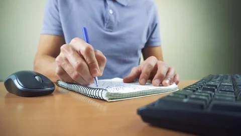 Close up of hands typing on computer keyboard and mouse. Writing in notebook Video stock 84267445