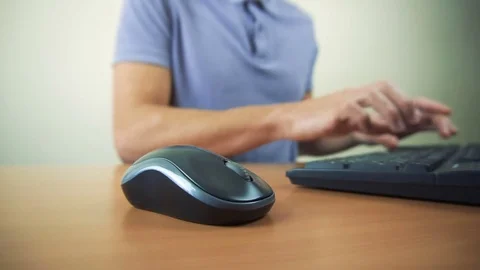 Close up of hands typing on computer keyboard and mouse Stock Footage 84497658