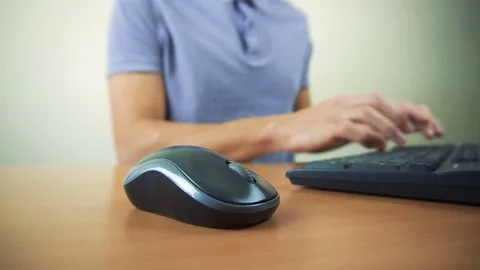 Close up of hands typing on computer keyboard and mouse Stock Footage 84497884
