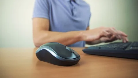 Close up of hands typing on computer keyboard and mouse Stock Footage 84498075