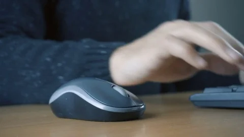 Close up of hands typing on computer keyboard and mouse Stock Footage 84499145