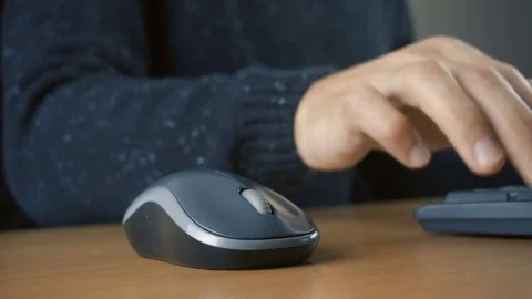 Close up of hands typing on computer keyboard and mouse Stock Footage 84500173