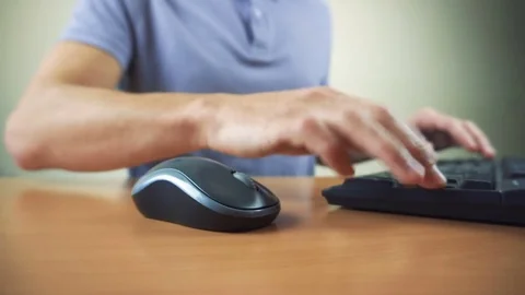 Close up of hands typing on computer keyboard and mouse Stock Footage 84500487