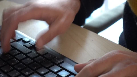 Close up of hands typing on the computer keyboard and then starting to throw ang Stock Footage 128067956