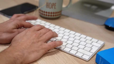 Close Up Hands Typing on Computer Keyboard at Office Desk Workspace with Coffee 스톡 동영상 332073356