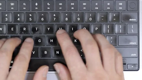 Close-up of hands typing on a computer keyboard, end of work Stock Footage 336560808