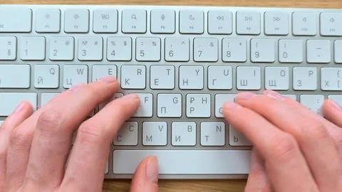 Close-up of hands typing on a computer keyboard. Top-down view showing fing.. Stock Footage 340283647