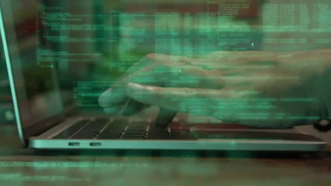 Close up of hands typing on a keyboard with animated code overlays on screen Stock Footage 334175288