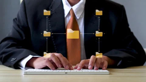 Close-up of hands typing on keyboard with animated central folder hierarchy and Stock Footage 347185126