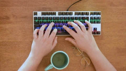 Close up of hands typing on keyboard. Brown background. Negative space. Stock Footage 134153206