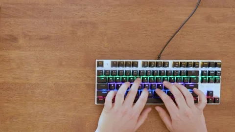 Close up of hands typing on keyboard. Brown background. Negative space. Stock Footage 134154166